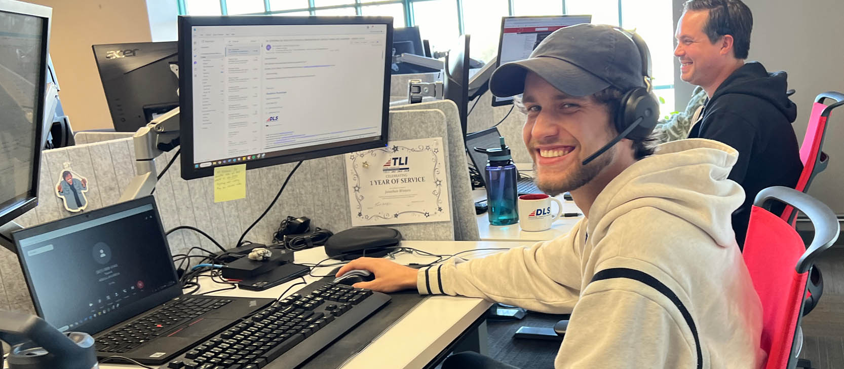 Smiling employees at computers