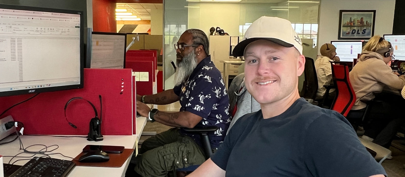 Office employee with headset smiling